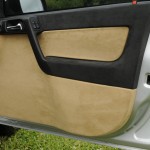 Precision custom door card finished in genuine alcantara