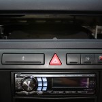 Audi A6 upfront subwoofer shown between the removed centre vents in dash board